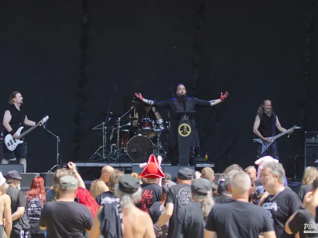 Wide shot of the band on the festival stage, vocalist with arms spread behind the lectern